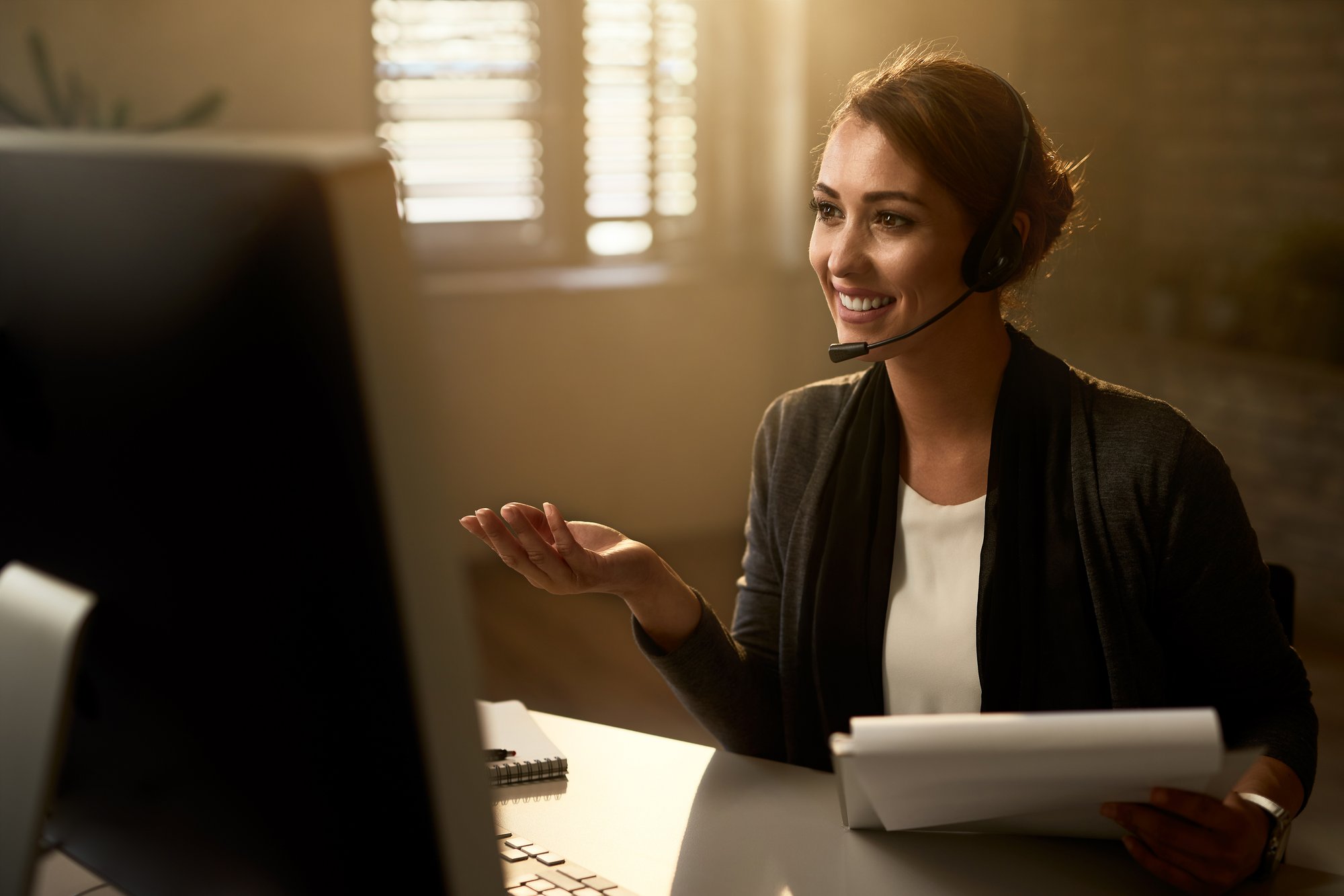 happy-customer-service-representative-using-computer-while-communicating-with-clients-online